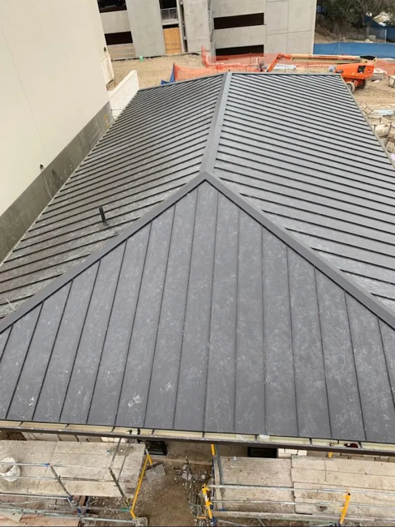 Commercial metal roof construction with crane equipment in Williamstown